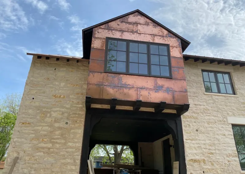 Copper metal panel facade on a stone building for Metal Roof Coating in Westwood